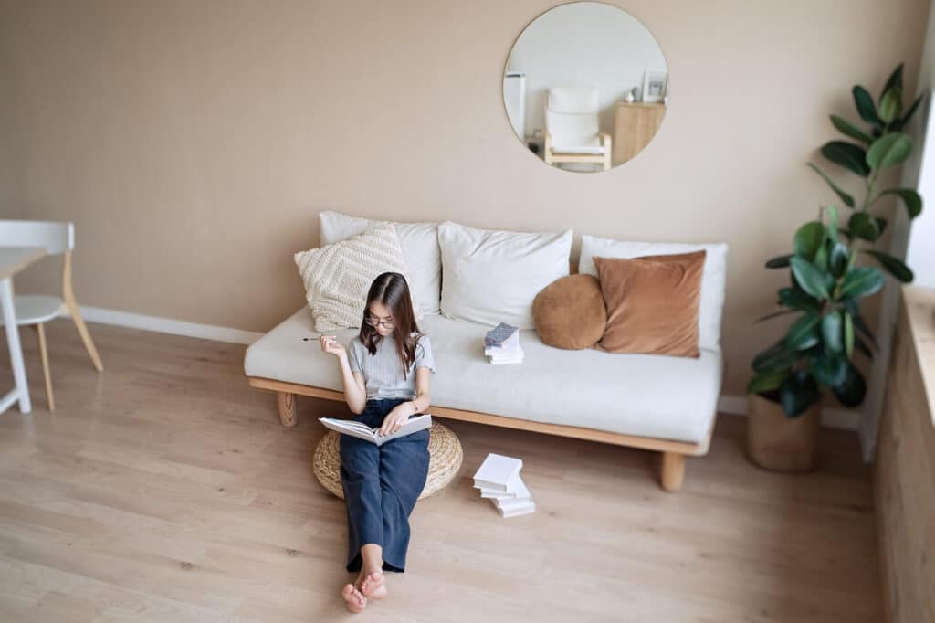 Girl,Sitting,On,The,Floor,At,Home,With